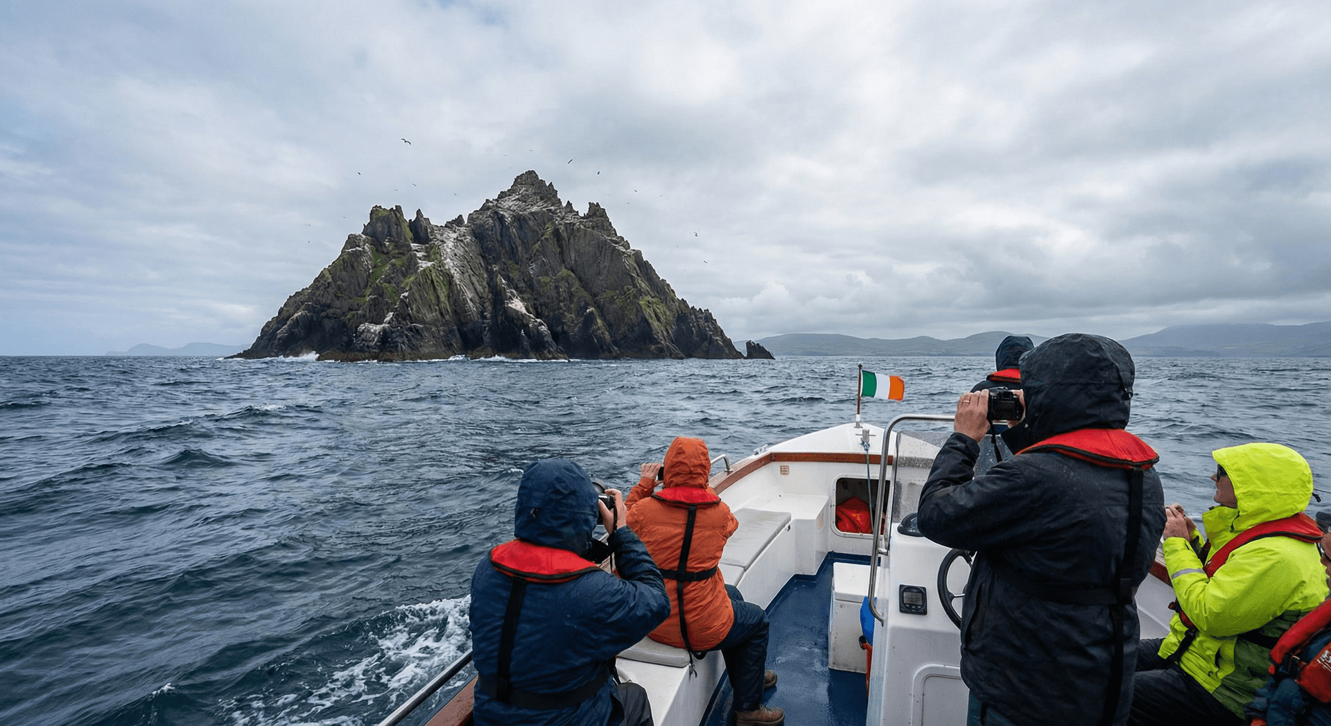 Small boat with tourists approaching Skellig Michael island from the sea