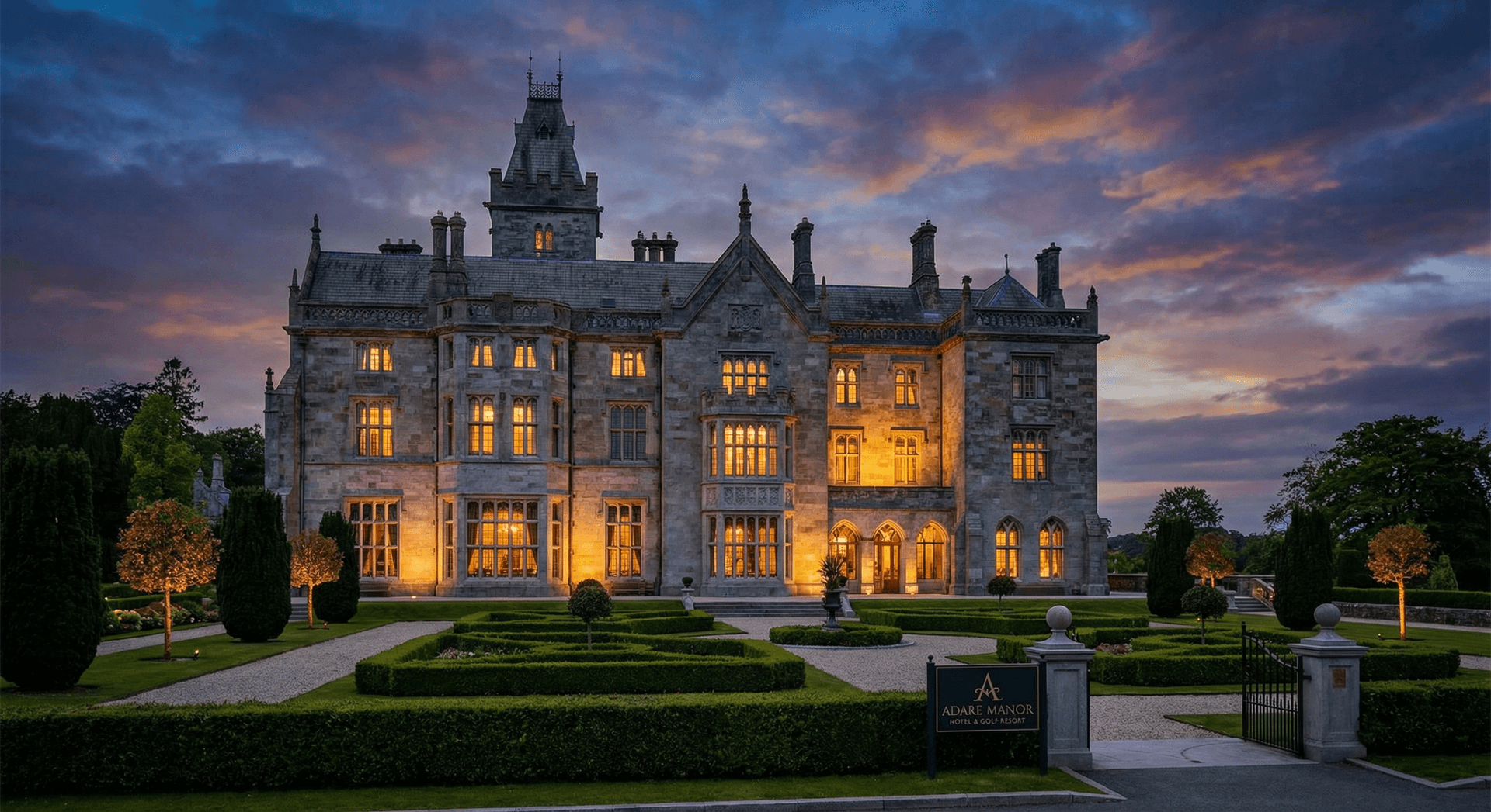 Majestic Irish castle hotel exterior at dusk with warm lights and gardens