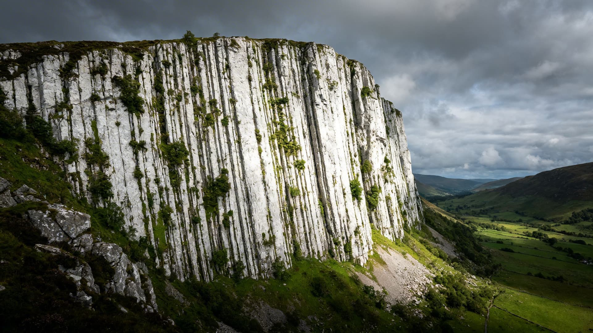 The white limestone cliff face of Eagle's Rock rising sheer from the valley floor near Glenade in the Dartry Mountains of County Leitrim