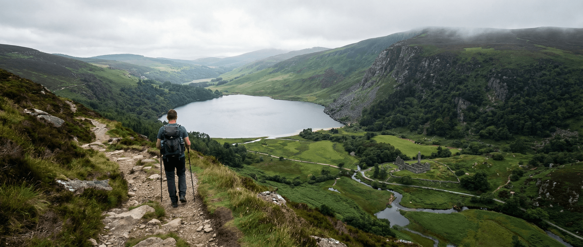 Hiker on mountain trail above Glendalough lakes