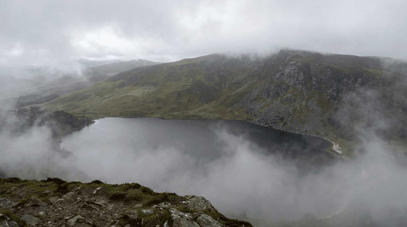 Lough Tay partially obscured by mist and low clouds, mysterious atmospheric conditions