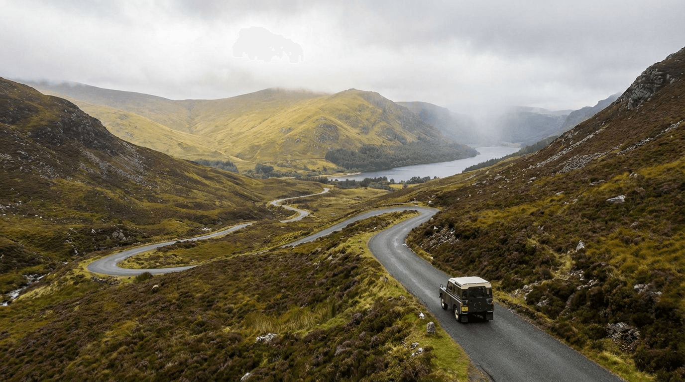 Narrow winding road through the Wicklow mountains, approaching Lough Tay with scenic views