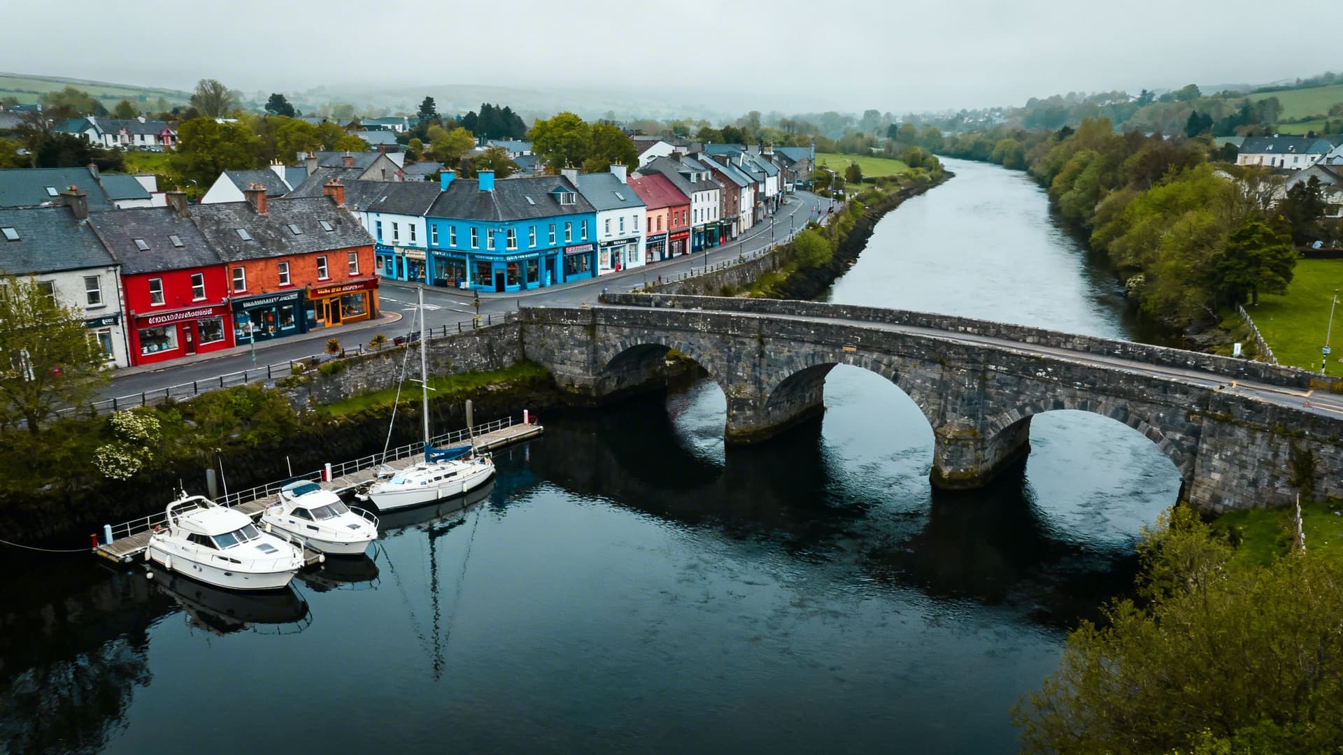Small boats moored in the marina at Carrick-on-Shannon with the compact town centre visible along the River Shannon in County Leitrim