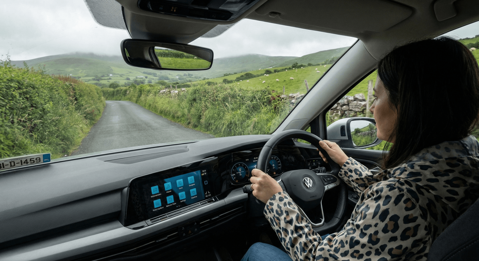 Compact rental car on narrow winding Irish country road